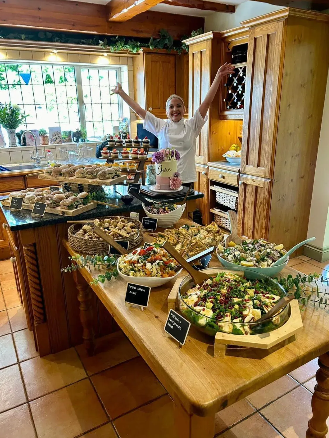 Rustic wooden board loaded with savory grazing items, cheeses, and crackers